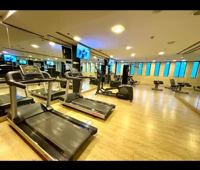 a gym with treadmills and machines in a room at Amman damac tower عبدلي عمان دماك Abdali Boulevard in Amman