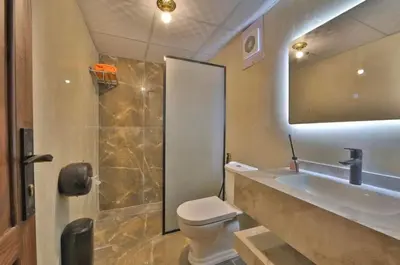 a bathroom with a toilet and a sink and a mirror at Gakleen luxury camp in Aqaba
