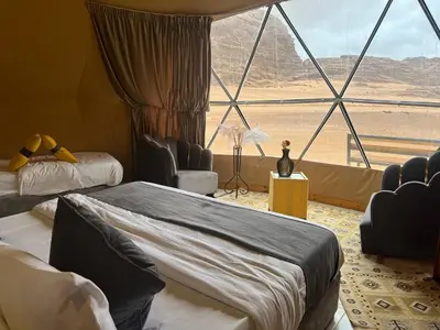 a room with two beds and a view of the desert at Gakleen luxury camp in Aqaba