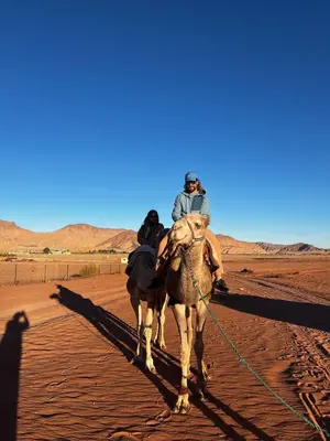 a man riding a camel in the desert at Gakleen luxury camp in Aqaba