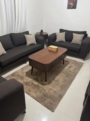 a living room with couches and a coffee table at Bonuk House in Kufayrāt Abū Khīnan