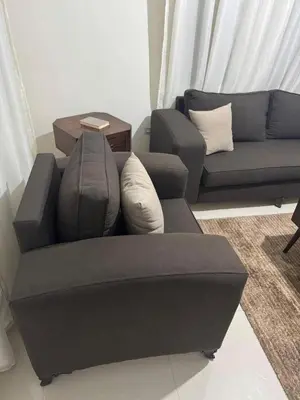 a living room with a couch and a table at Bonuk House in Kufayrāt Abū Khīnan