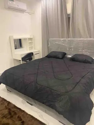 a bedroom with a large bed and a desk at Cozy, Newly Furnished & Budget Friendly Apartment in Amman