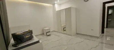 a bathroom with a mirror and a trash can at Cozy, Newly Furnished & Budget Friendly Apartment in Amman