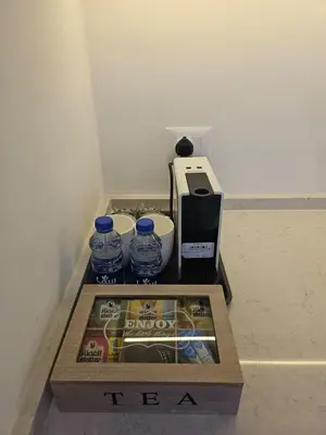 a box with bottles of water and a coffee maker at Shamsi Apartments 008 in Amman
