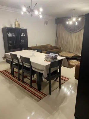 a dining table and chairs in a living room at نسيم الرمثاء in Ar Ramthā