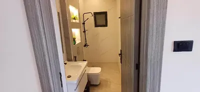 a small bathroom with a toilet and a sink at LV Spring Water Resort in Mukāwir