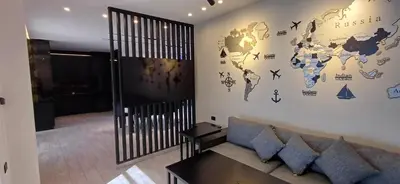 a living room with a couch and a world map on the wall at LV Spring Water Resort in Mukāwir