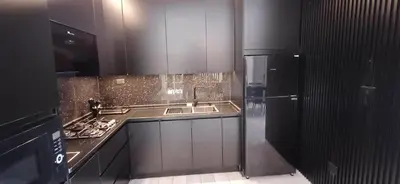 a kitchen with a sink and a stove top oven at LV Spring Water Resort in Mukāwir