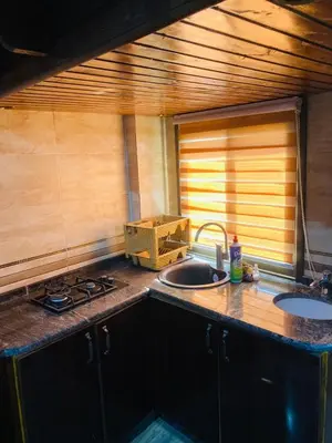 a kitchen with a sink and a counter top at Bedouin House in Jurf ad Darāwīsh
