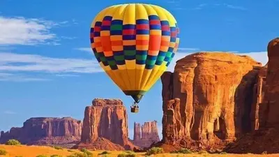 a hot air balloon flying over the desert at Faraj wadi rum in Disah