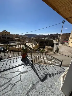 a balcony with a fence and a potted plant on it at Sewar hostel in Petra
