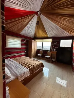a bedroom with a large bed in a tent at Desert Sands Camp Wadi Rum in Wadi Rum