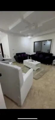 a living room with a couch and a table at Beautiful Apartment in irbid in Aydūn