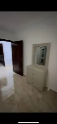 a white room with a dresser and a mirror at Beautiful Apartment in irbid in Aydūn