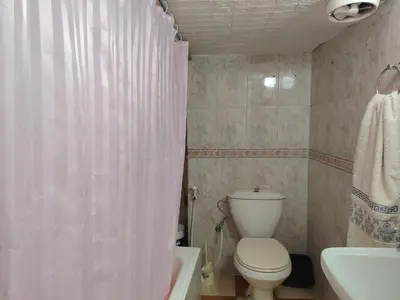 a bathroom with a toilet and a sink and a shower curtain at بيت الحجر in Amman