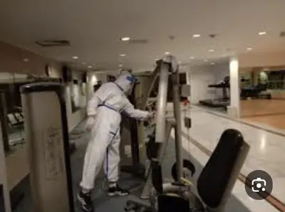 a man in white uniform working in a store at بيت الحجر in Amman