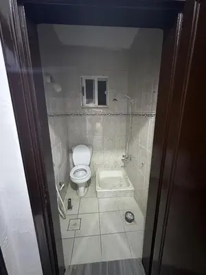 a small bathroom with a toilet and a shower at Beautiful apartment in Irbid