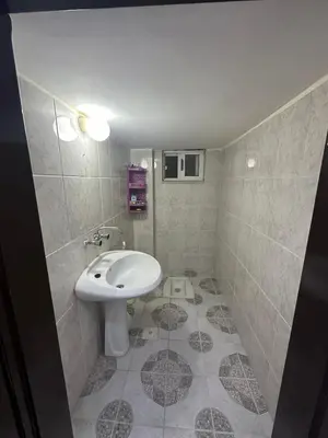a bathroom with a sink and a toilet at Beautiful apartment in Irbid