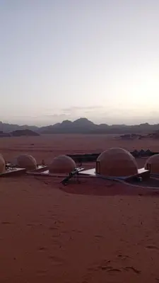 a group of domes in the middle of the desert at Suleman Bedouin Life Camp in Wadi Rum