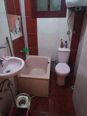 a small bathroom with a toilet and a sink at جبال الاردن in Amman