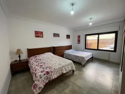 a bedroom with two beds and a window at Luxury spacious house in dabouq with parking in Amman