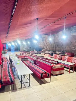 a store with rows of red benches and tables at Desert Star Camp in Wadi Rum