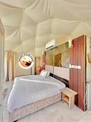 a bedroom with a bed in a tent at RUM BULSE BUBBLE lUXURY CAMP in Disah