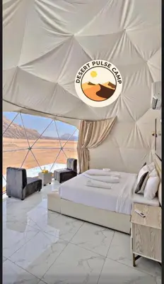 a bedroom with a bed in a tent at RUM BULSE BUBBLE lUXURY CAMP in Disah