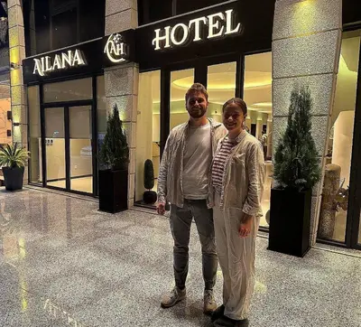 a man and woman standing in front of a hotel at Ailana Hotel in Aqaba