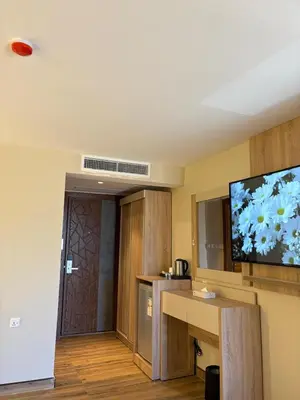 a kitchen with a flat screen tv on the wall at Ailana Hotel in Aqaba
