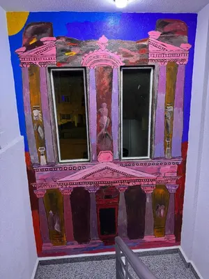 a room with a painting of a building on the wall at Petra Rocks Hotel in Wadi Musa