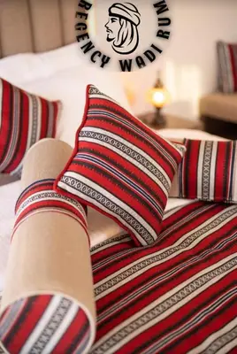 a bed with pillows on it with a sign on it at Regency Bubble Wadi Rum in Wadi Rum