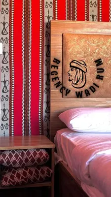 a bedroom with a bed and a sign that says happy world at Regency Bubble Wadi Rum in Wadi Rum