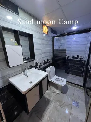 a bathroom with a sink and a toilet at Wadi Rum Sand moon Camp &Tour in Wadi Rum