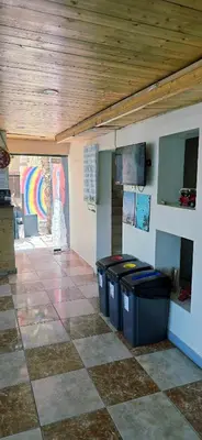 a room with trash cans and a wooden ceiling at Rafiki Hostel in Wadi Musa