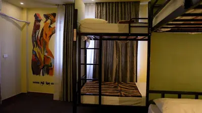 a bedroom with two bunk beds in a room at Rafiki Hostel in Wadi Musa