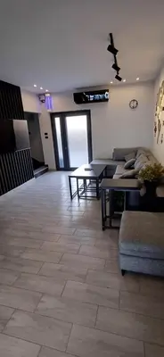 a living room with a couch and a table at LAVA Resort Hot spring water in Mukāwir