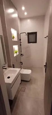 a white bathroom with a sink and a toilet at LAVA Resort Hot spring water in Mukāwir