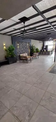 an empty lobby with benches and a stone wall at LAVA Resort Hot spring water in Mukāwir