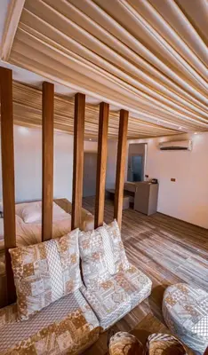 a living room with a bed and a couch at مخيم خيال رم in Jurf ad Darāwīsh