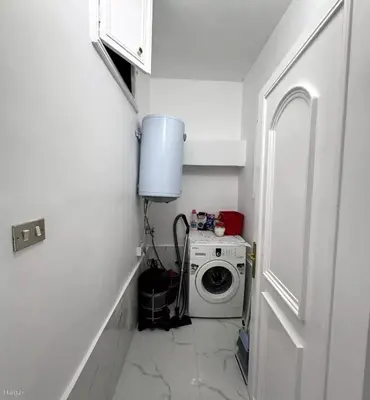 a white laundry room with a washing machine in it at شقة مفروشة للايجار مميزه هادئه امنه ذات اطلاله رائعه in Amman