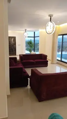 a living room with two couches and a couch at Munifah Grand Hills Chalet and Farm in Jurf ad Darāwīsh