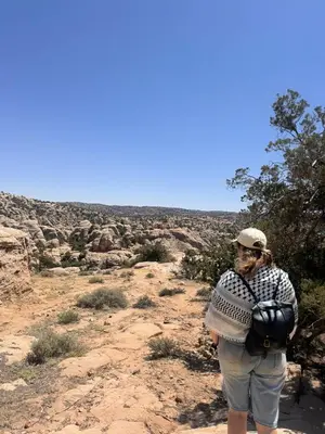 a man standing on a trail in the desert at Dana bedouin Sky in Dana