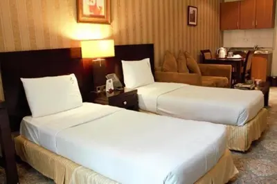 a hotel room with two beds and a couch at المناره ان in Amman