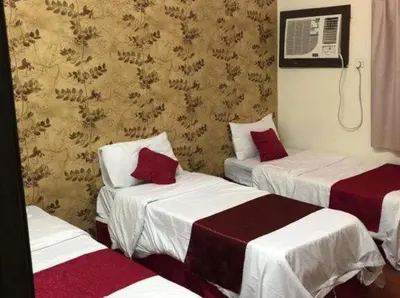 a hotel room with two beds and a fan at المناره ان in Amman