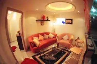 a living room with a red couch and a chair at المناره ان in Amman