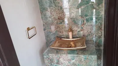 a bathroom with a dog in a sink with a candle at Cosy family apartment in Amman in Amman