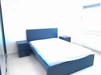 a bedroom with a blue bed and two night stands at Cosy family apartment in Amman in Amman