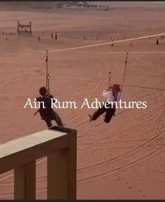 a person sitting on a swing on a beach at مغامرات عين رم in Wadi Rum